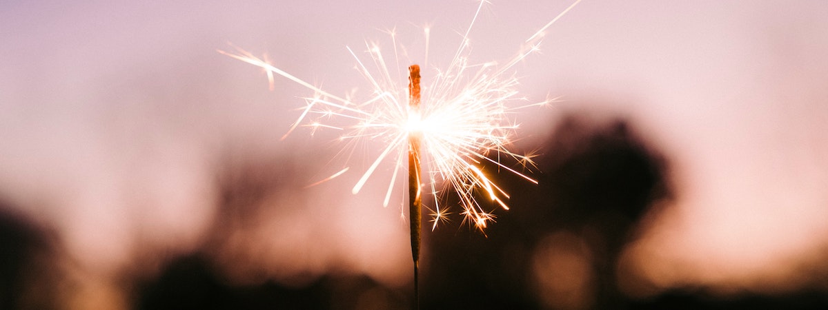 A lighted sparker against the evening sky